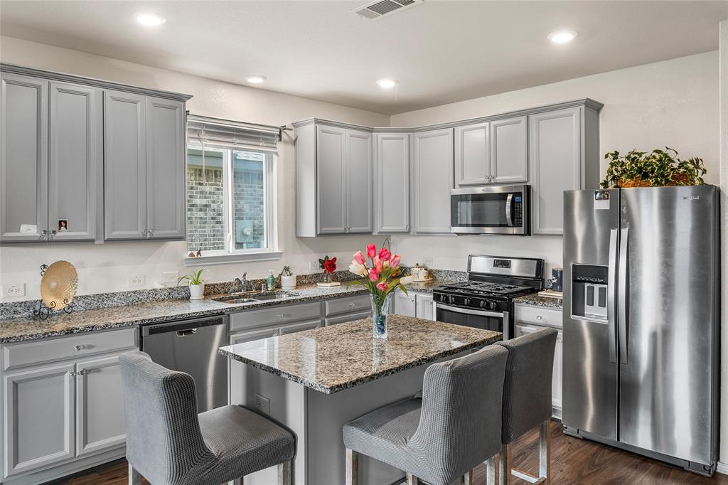 a kitchen with a sink stove and refrigerator