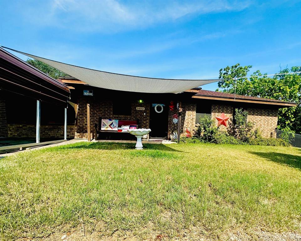 a front view of house with yard and outdoor seating