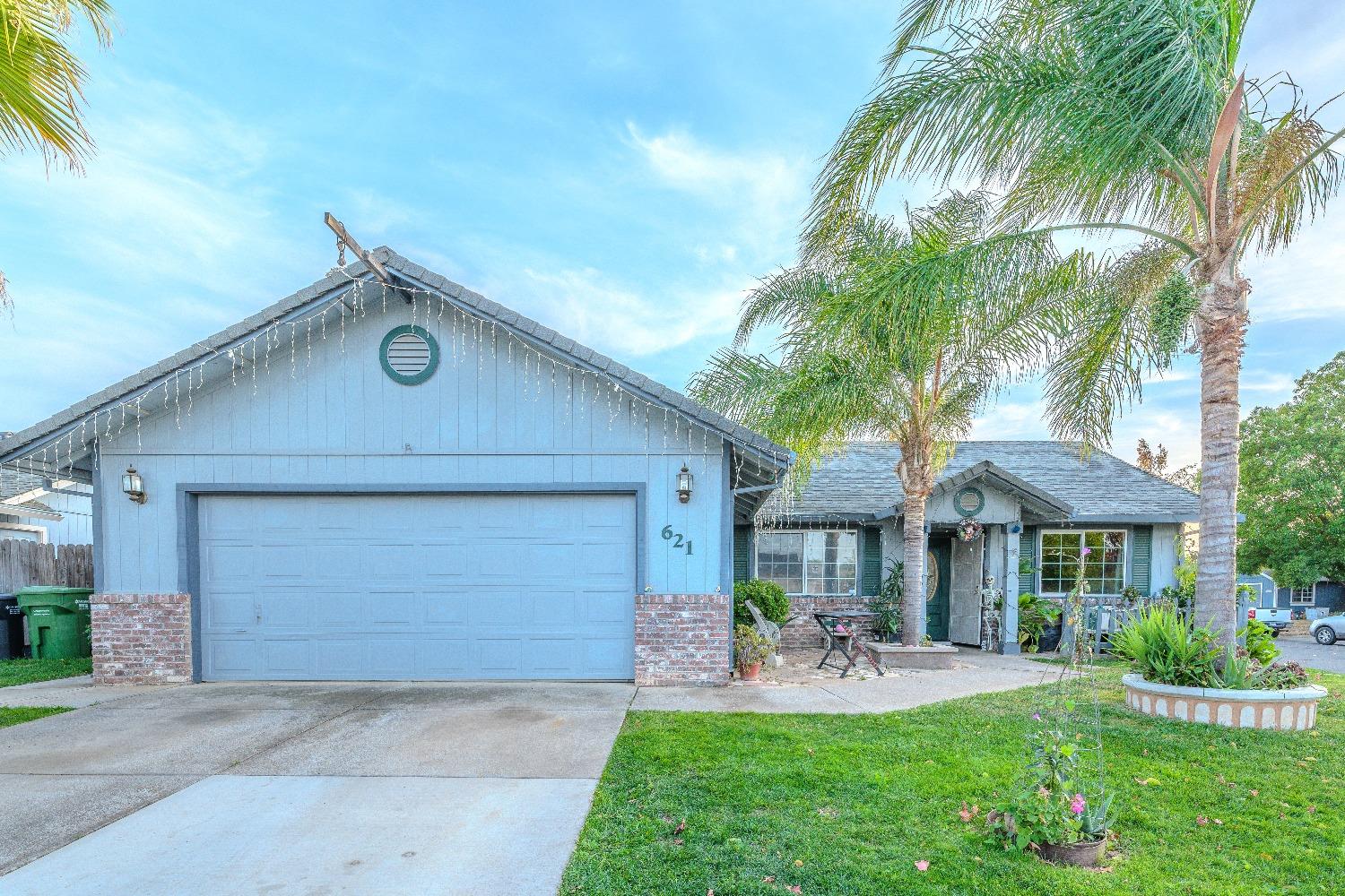 a front view of a house with a yard garage and outdoor seating