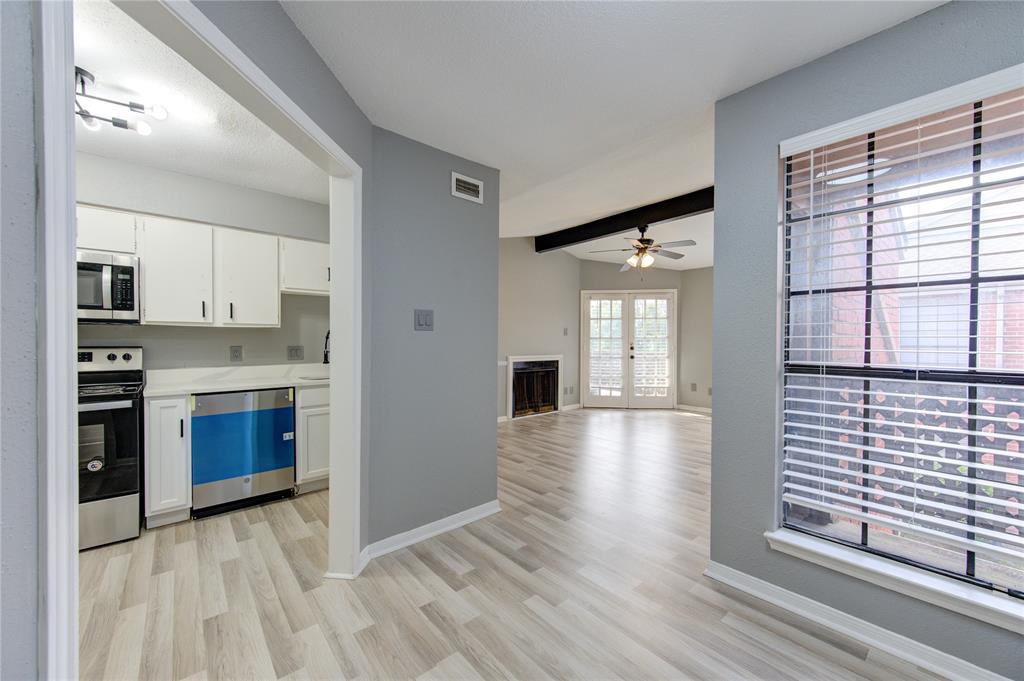 a view of kitchen with sink and refrigerator