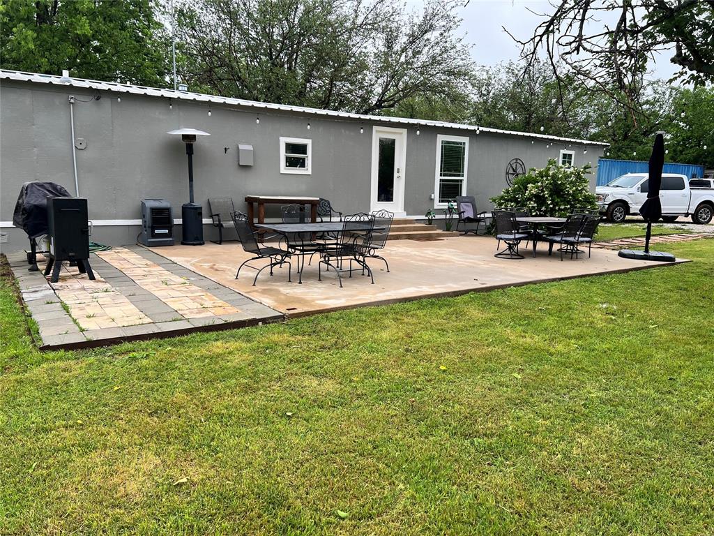 a view of a backyard and a patio