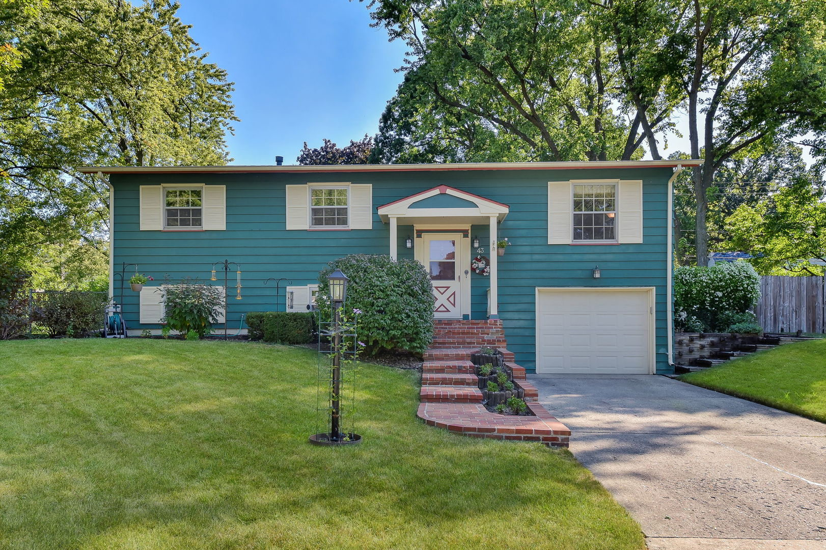 a front view of house with yard and green space