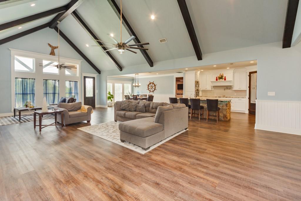 a living room with lots of furniture and wooden floors