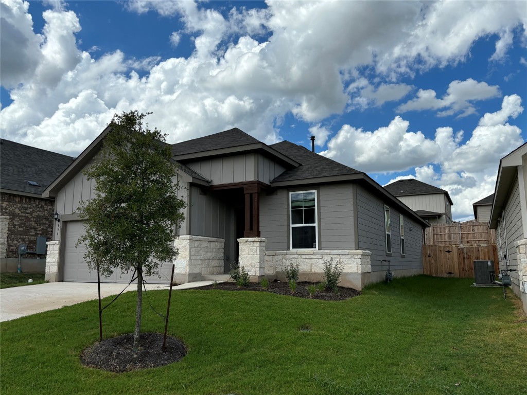 a front view of a house with a garden