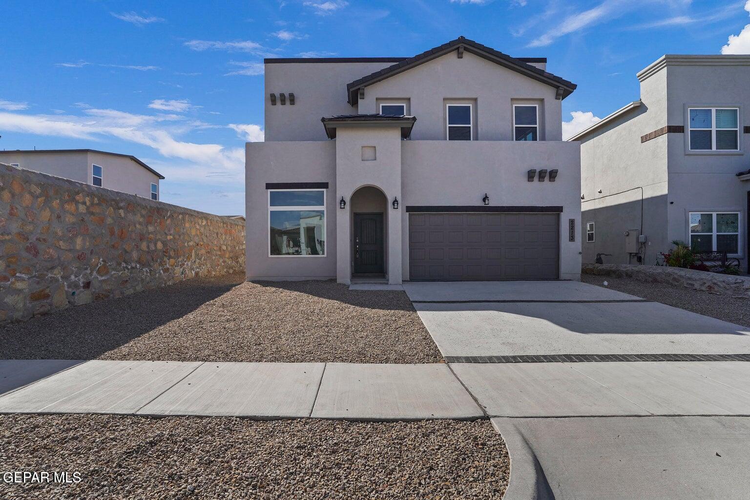 a front view of a house with white fence