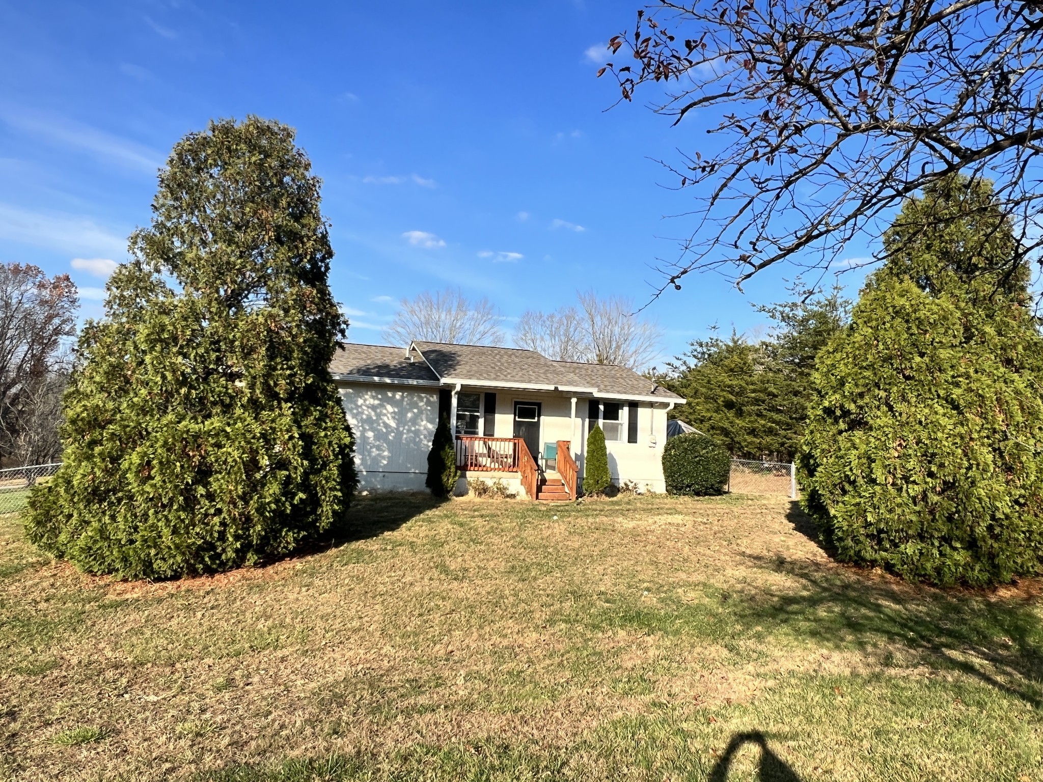 a view of a white house with a yard