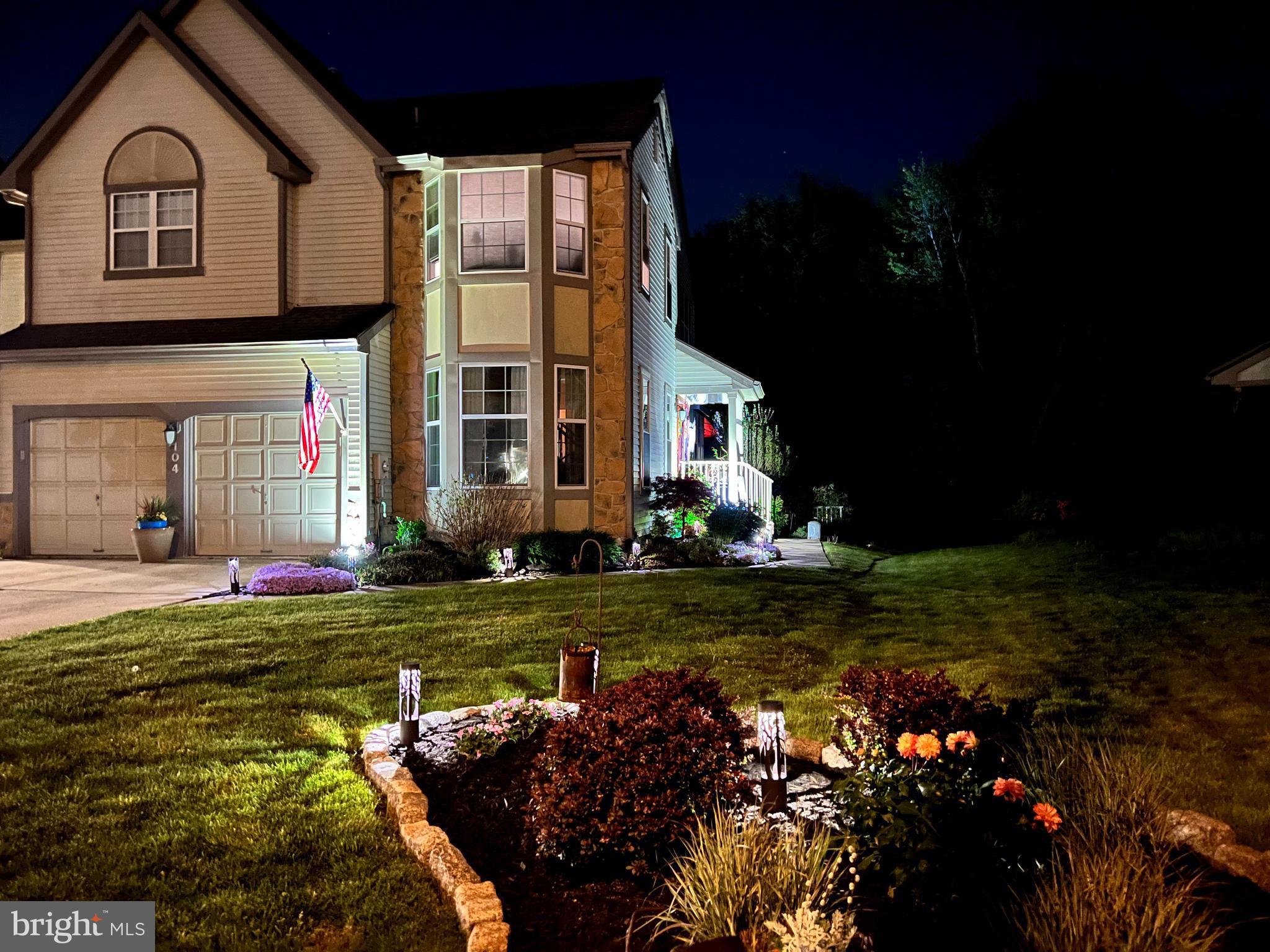 a front view of a house with a garden and pathway