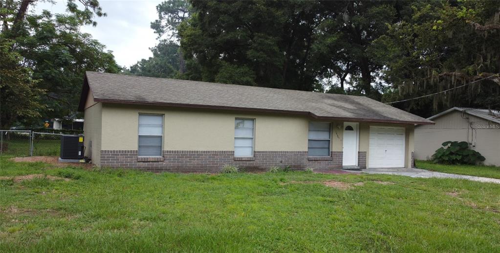 a front view of a house with a garden and yard