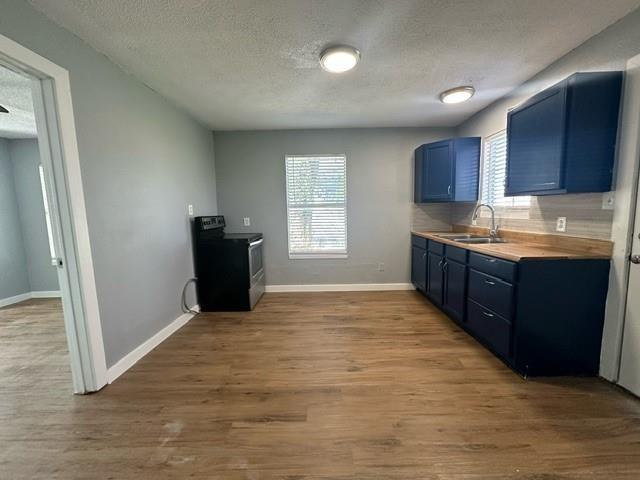 a view of kitchen with granite countertop cabinets and refrigerator