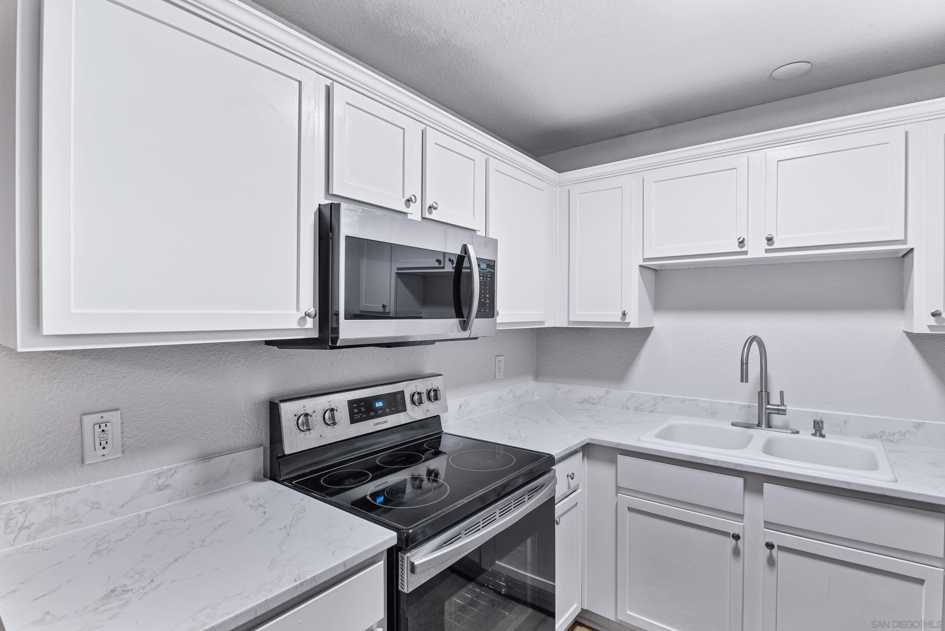 a kitchen with cabinets appliances and a sink