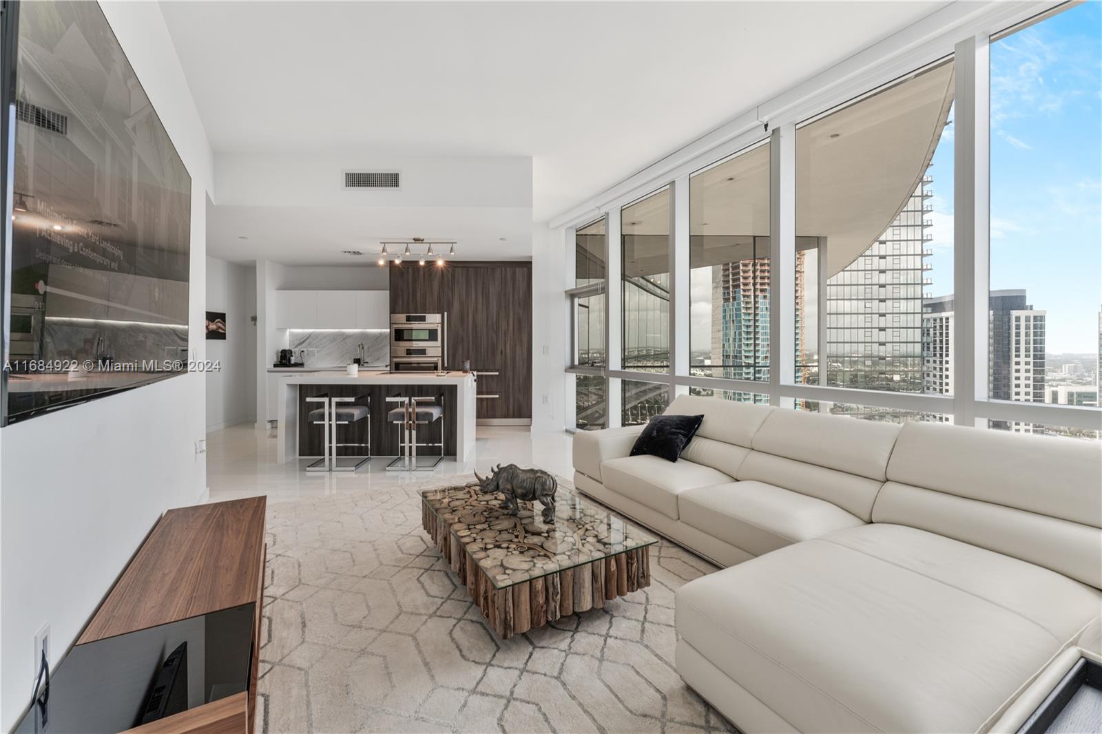 a living room with furniture and large windows