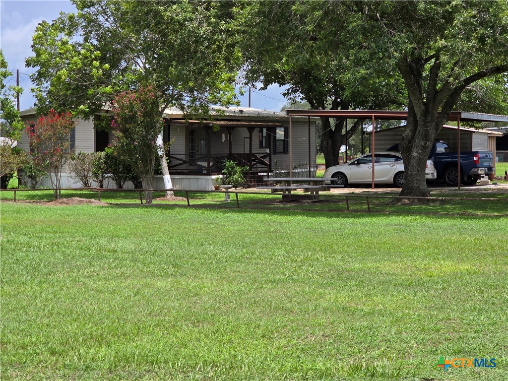 a front view of a house with a garden and sitting area