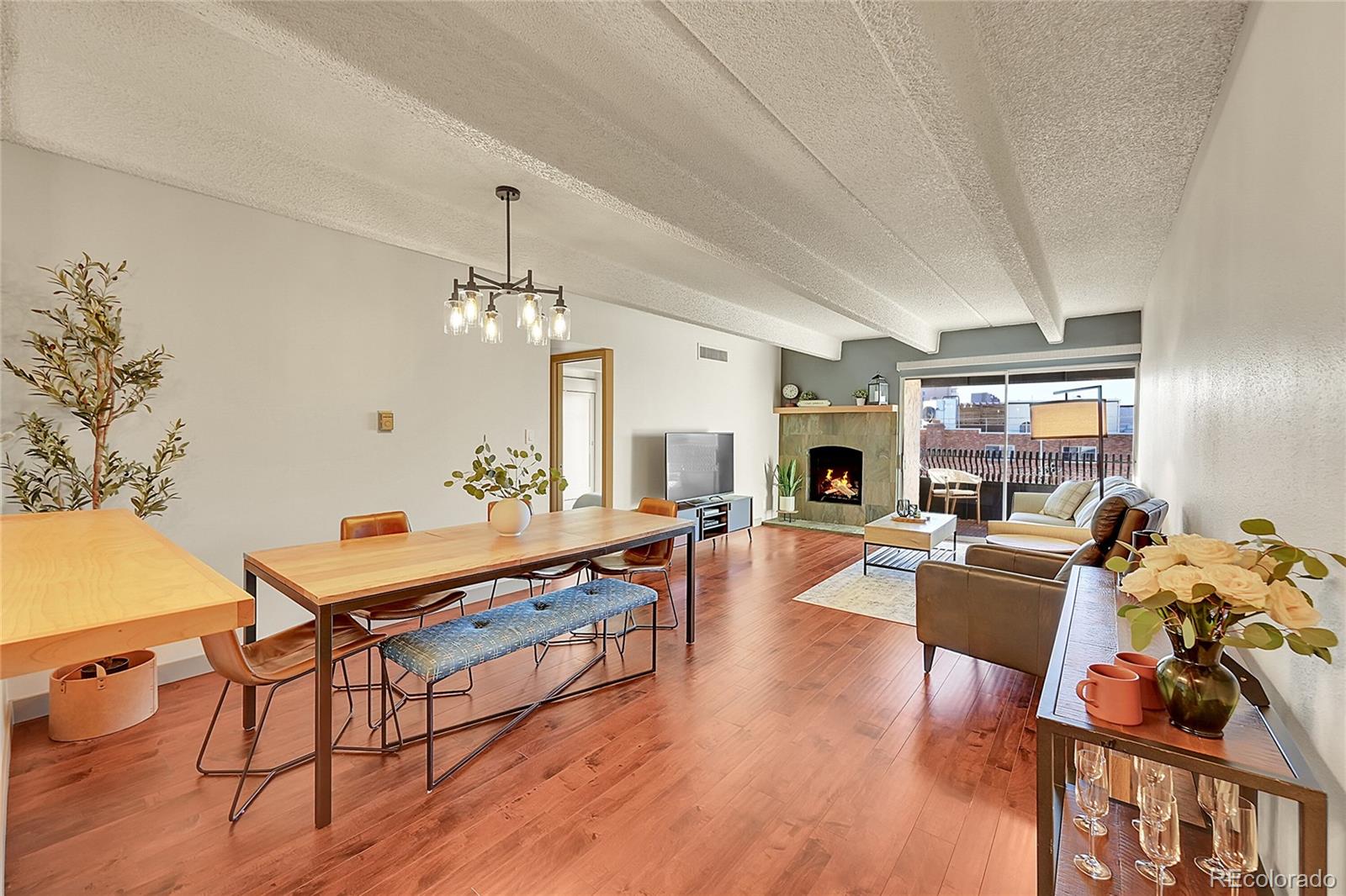 a living room with fireplace furniture and a wooden floor