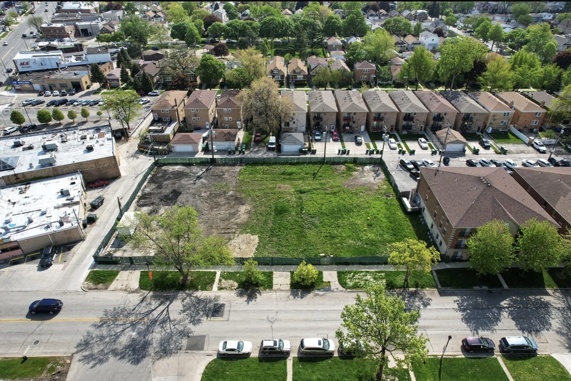 an aerial view of a house with a yard and lake view