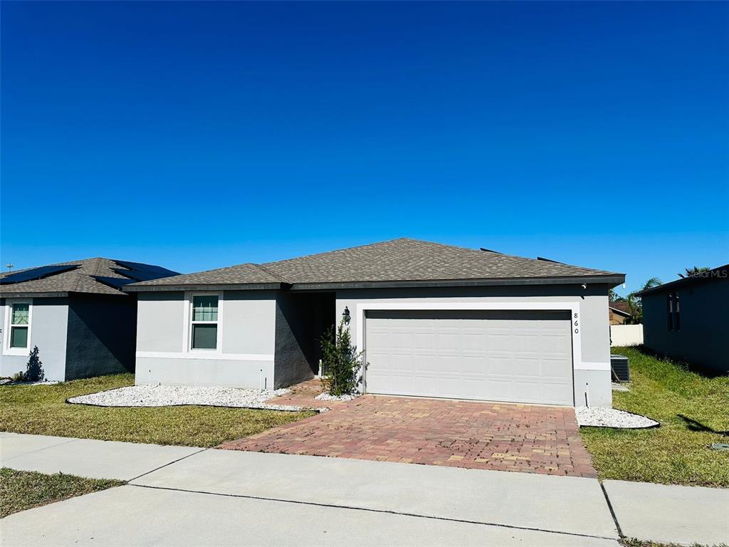 a front view of a house with a yard and garage