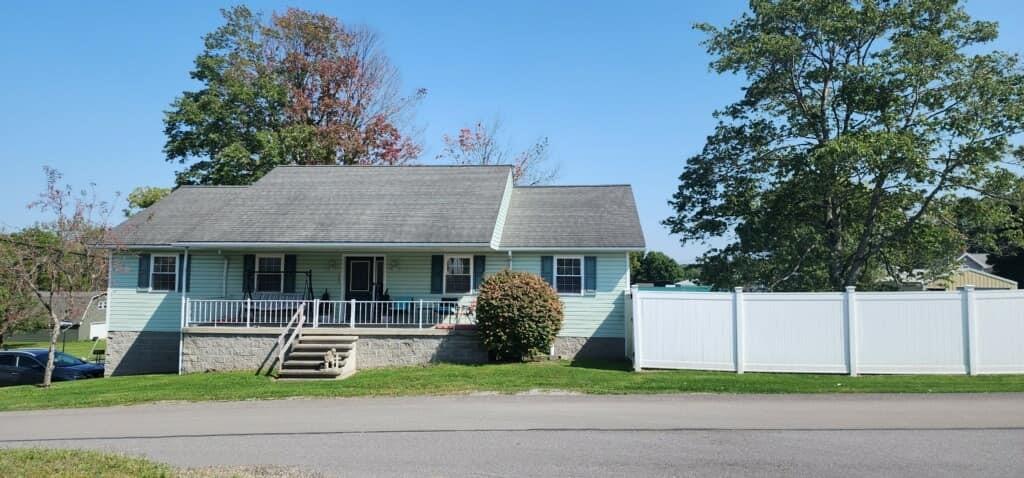 a front view of a house with a garden and plants