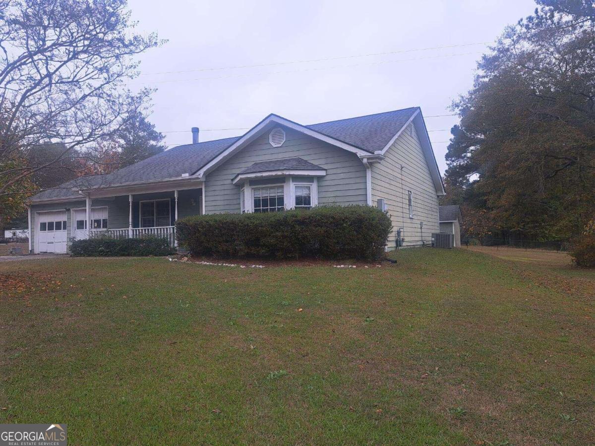 a front view of a house with a garden