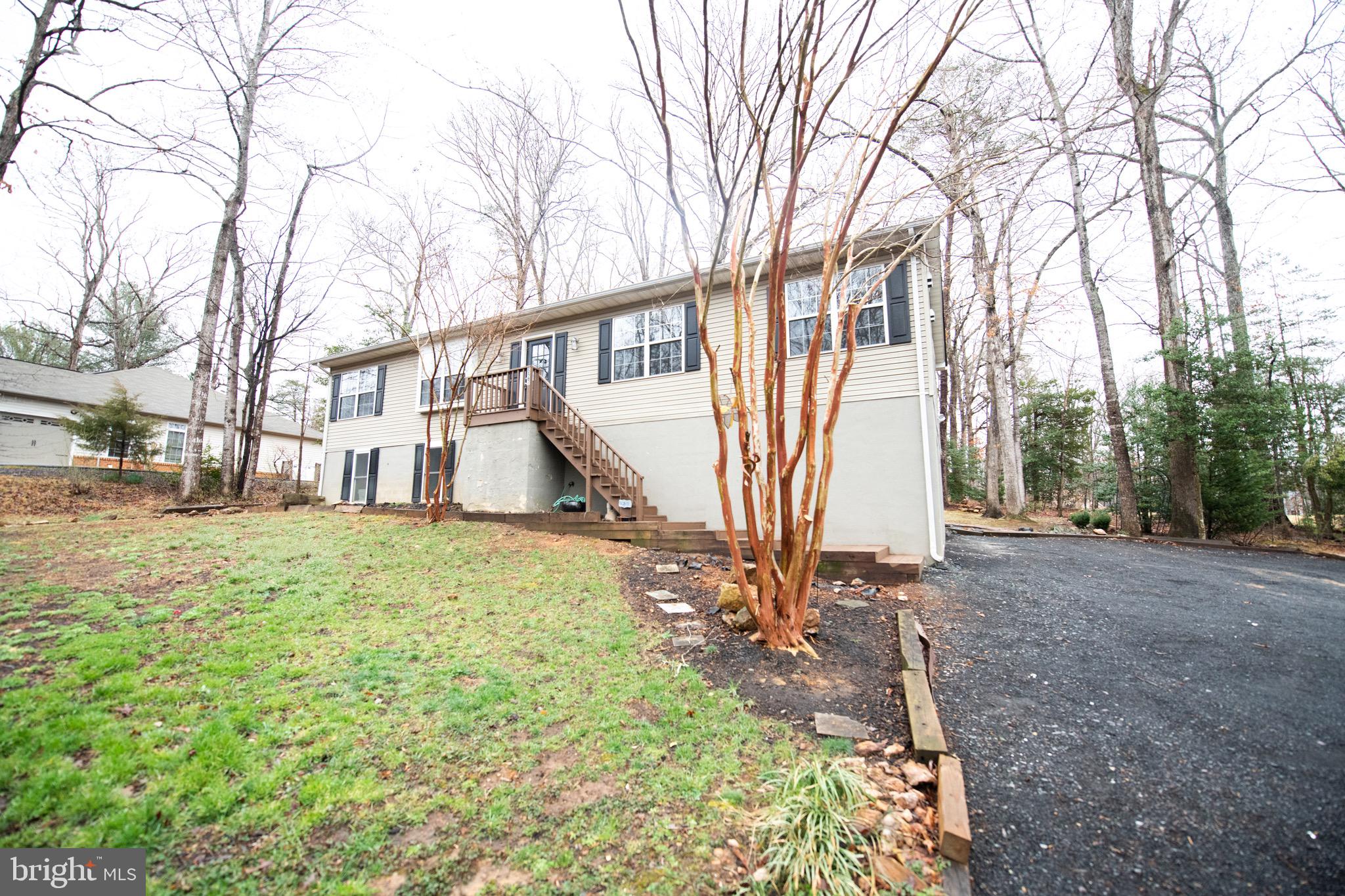 a view of a yard with a house and a tree