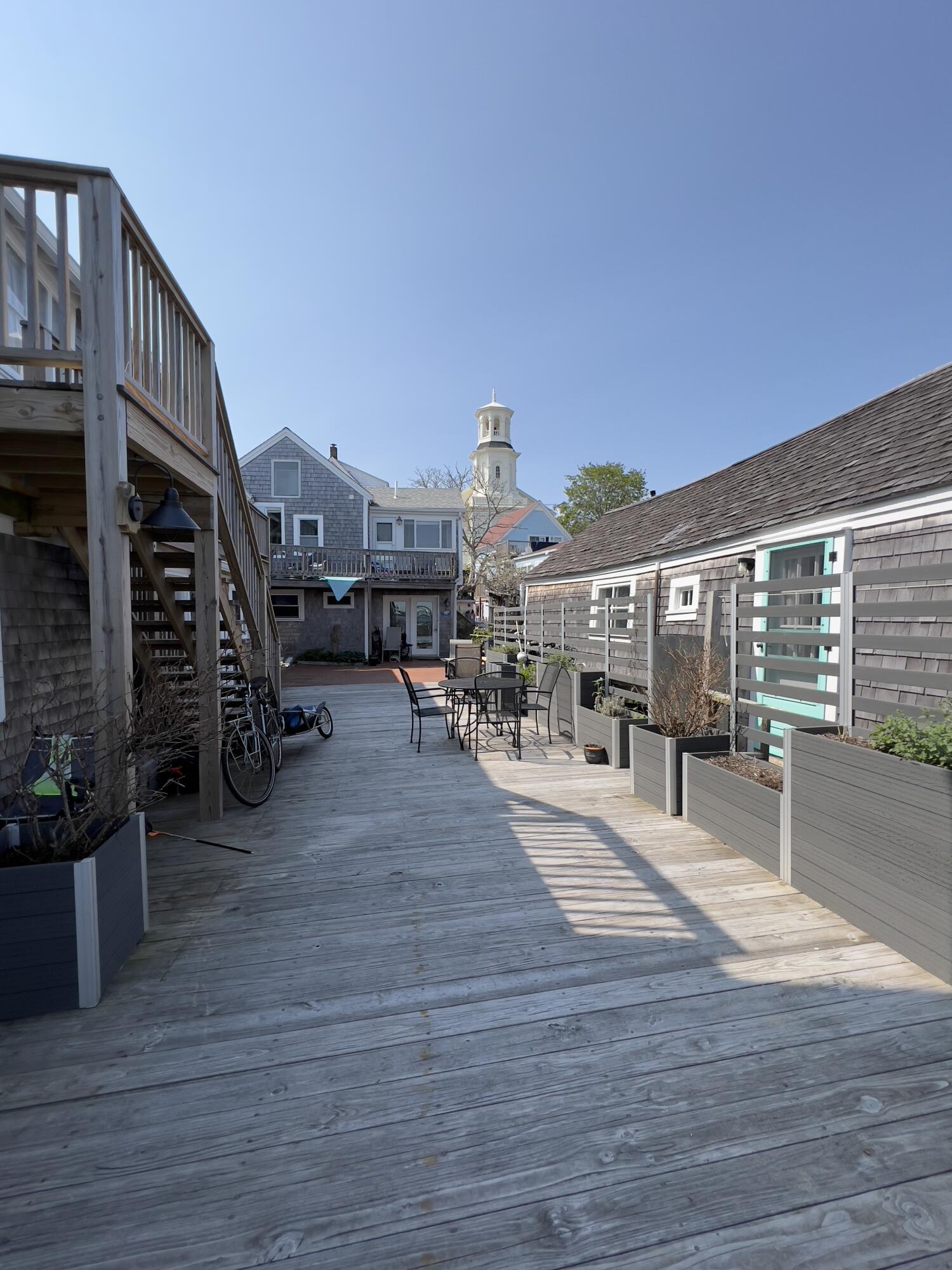 a view of a terrace with wooden floor and seating space