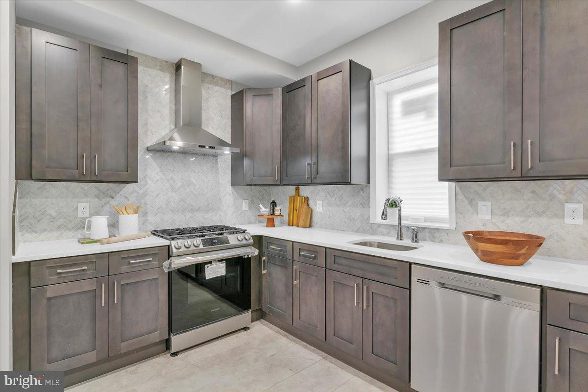 a kitchen with stainless steel appliances granite countertop a sink stove and cabinets