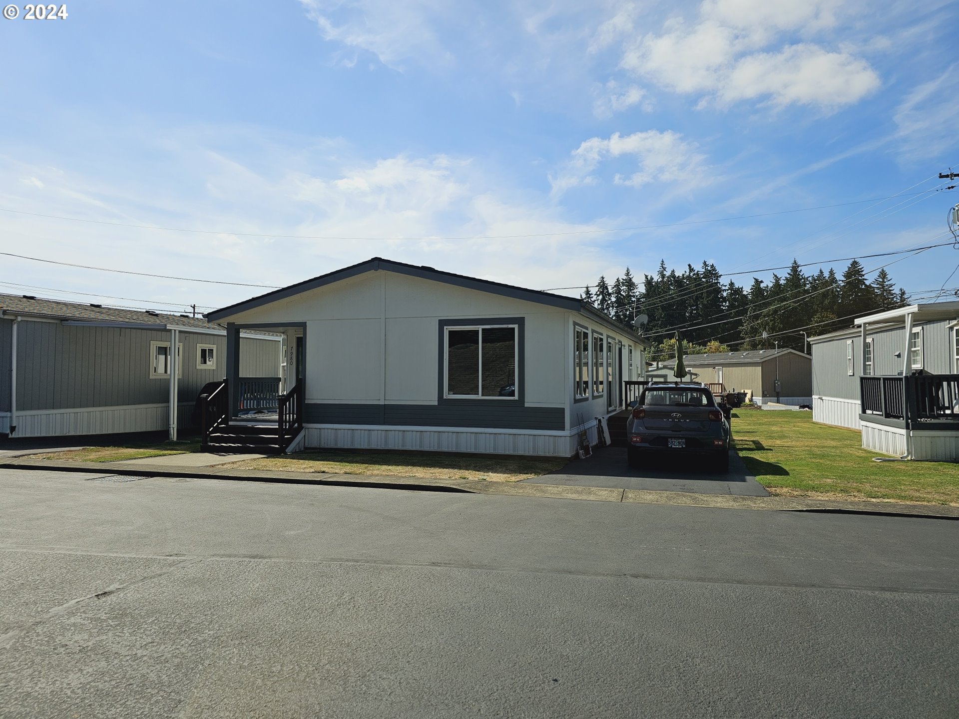 a view of a house with backyard and sitting area