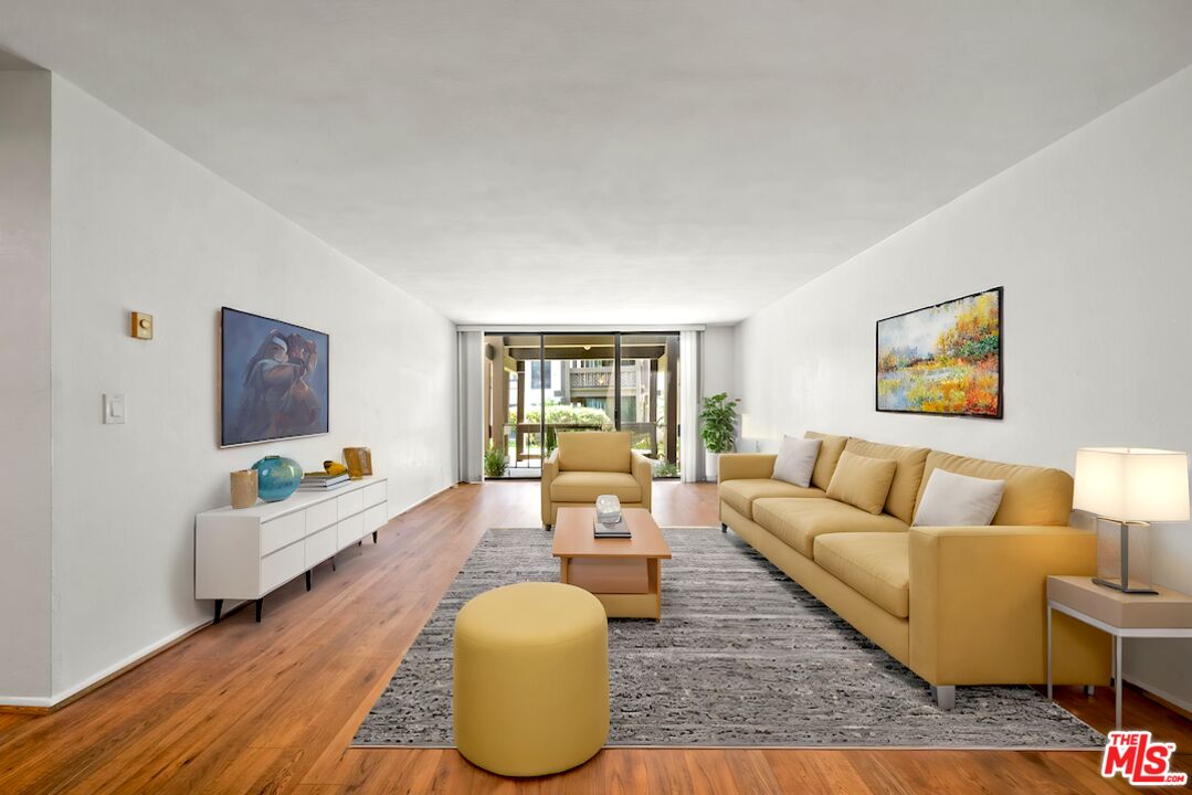 a living room with furniture and a large window