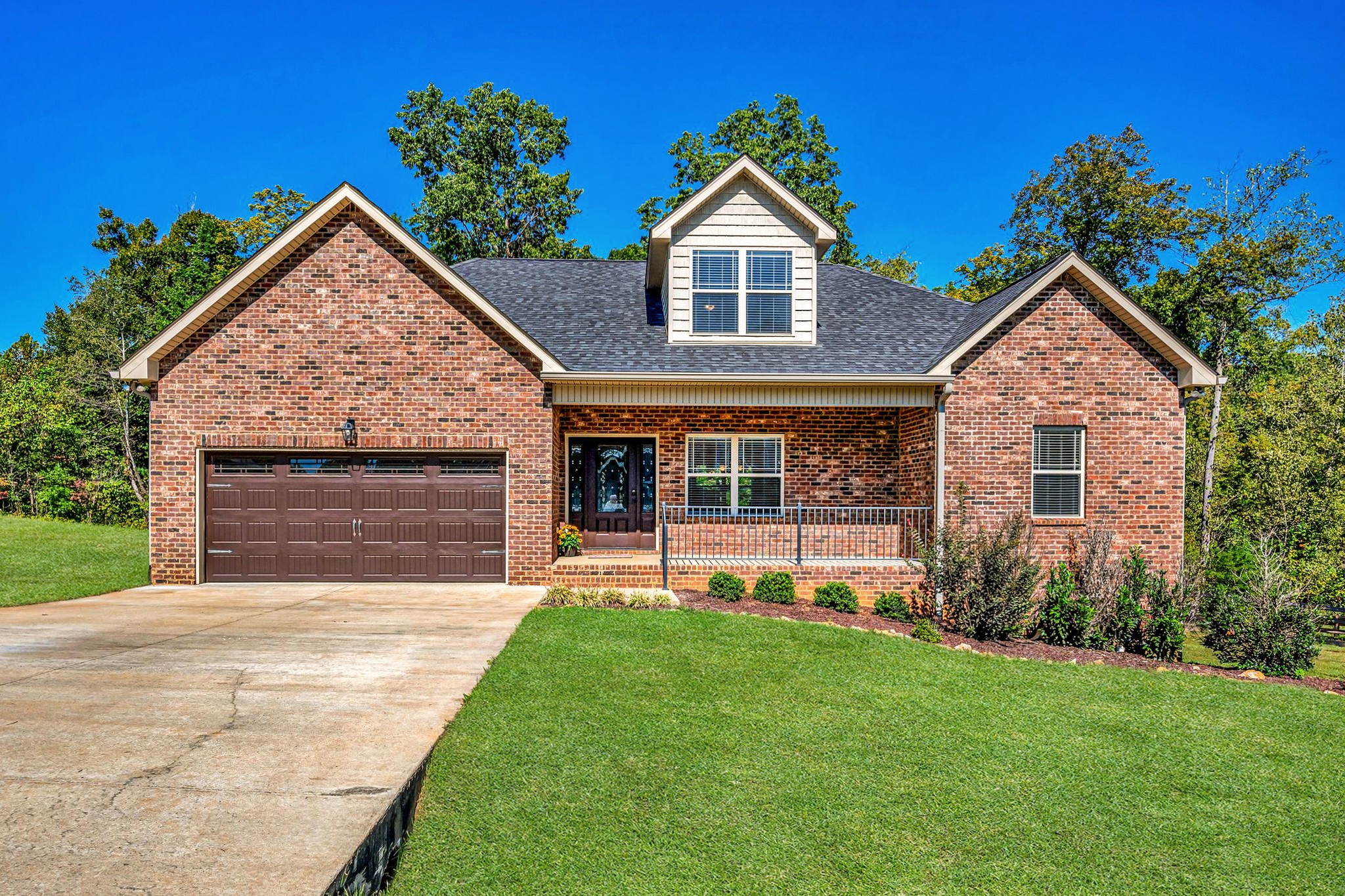 a front view of a house with a yard and garage