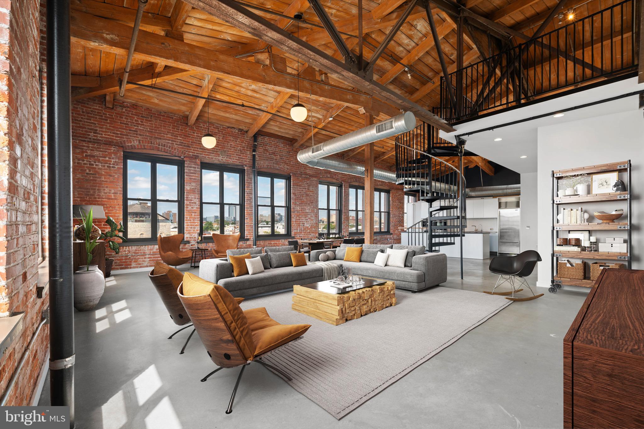 a living room with furniture a fireplace and a large window