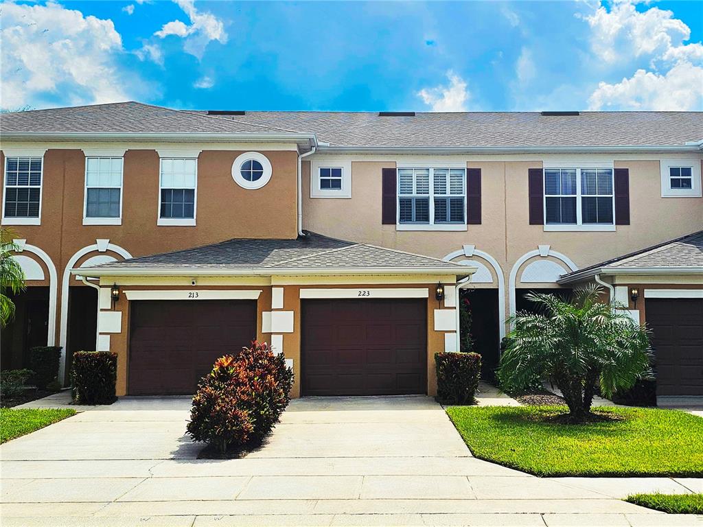 a front view of a house with a yard and garage