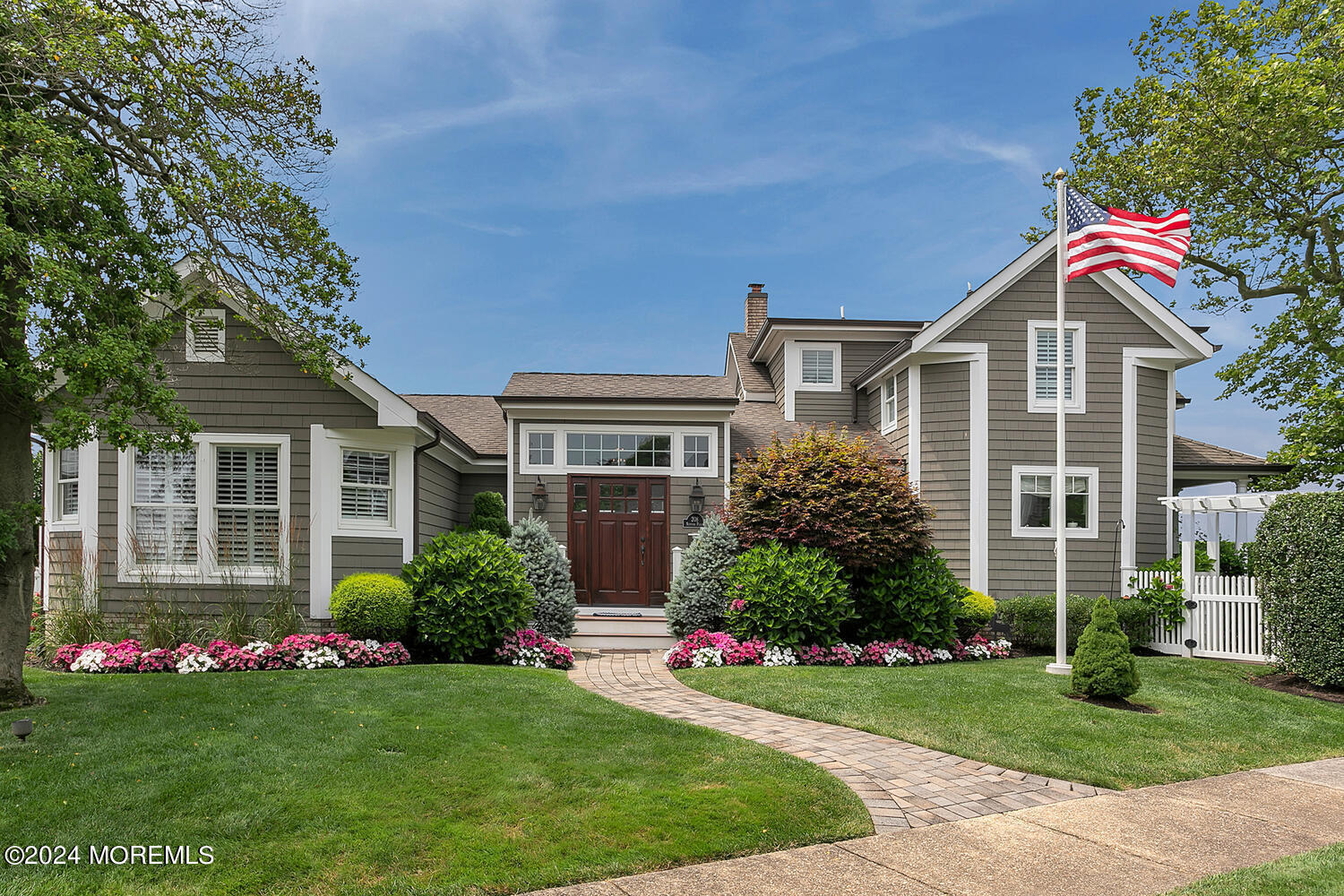 a front view of a house with a garden