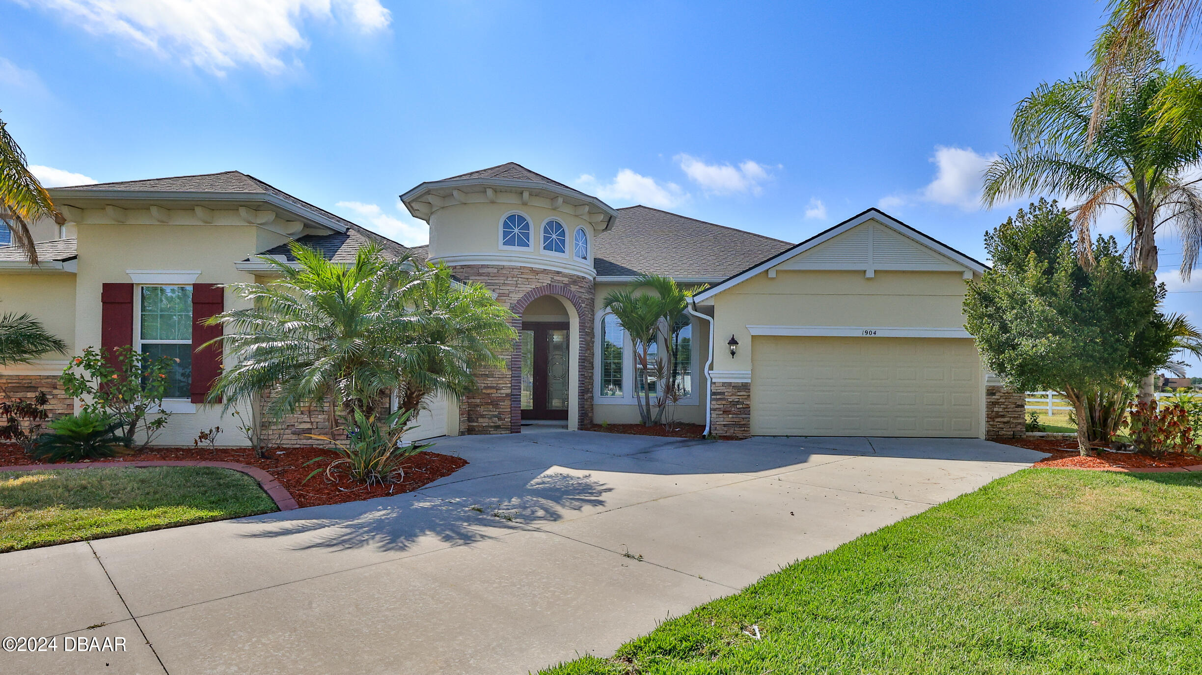 a front view of a house with a yard and garage