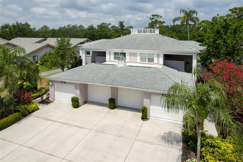 a aerial view of a house with a yard and potted plants