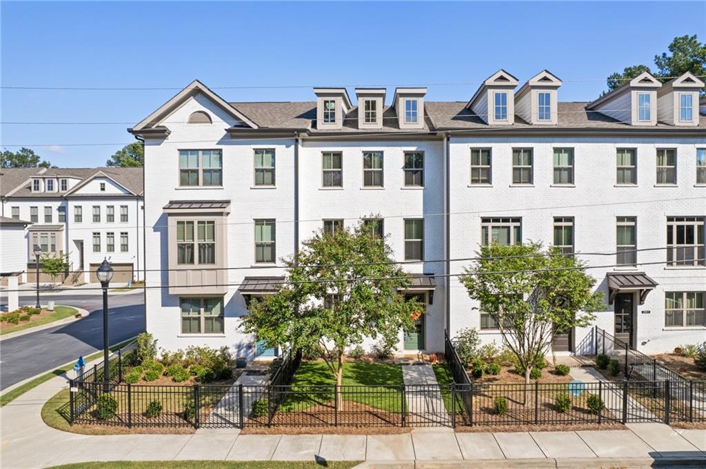 a front view of a residential apartment building with a yard