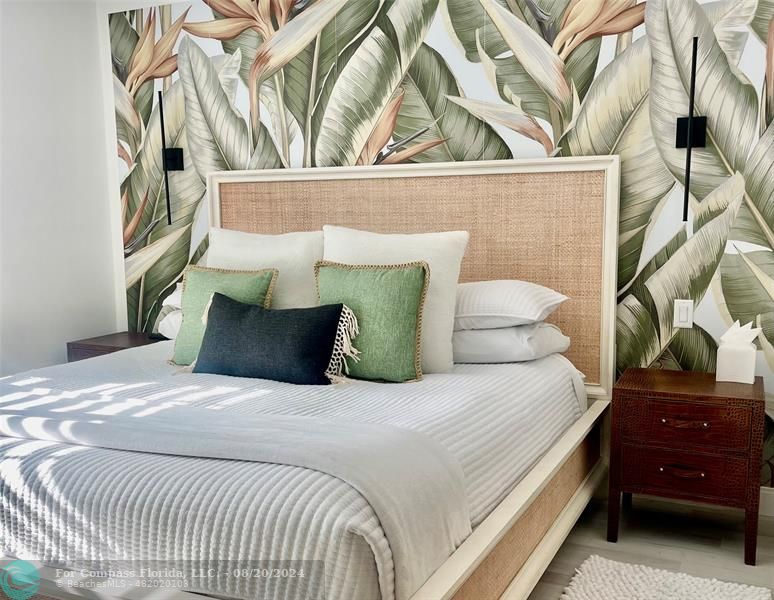 a bedroom with a bed and a black white bedspread