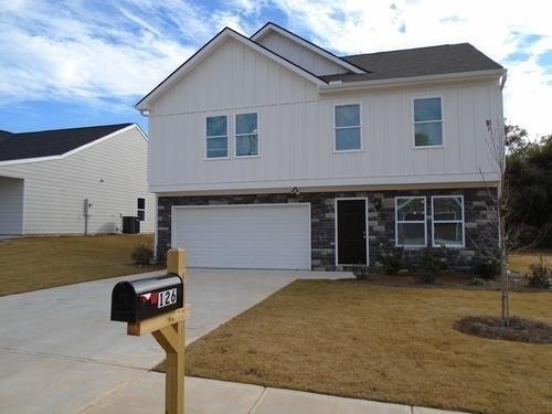 a front view of a house with garage