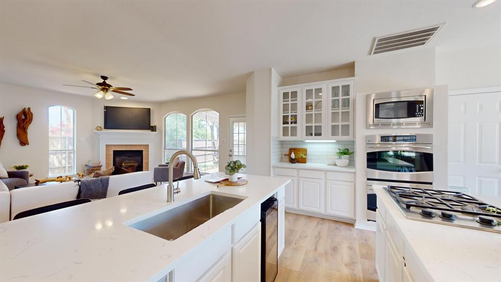 a kitchen with a stove a sink and a refrigerator