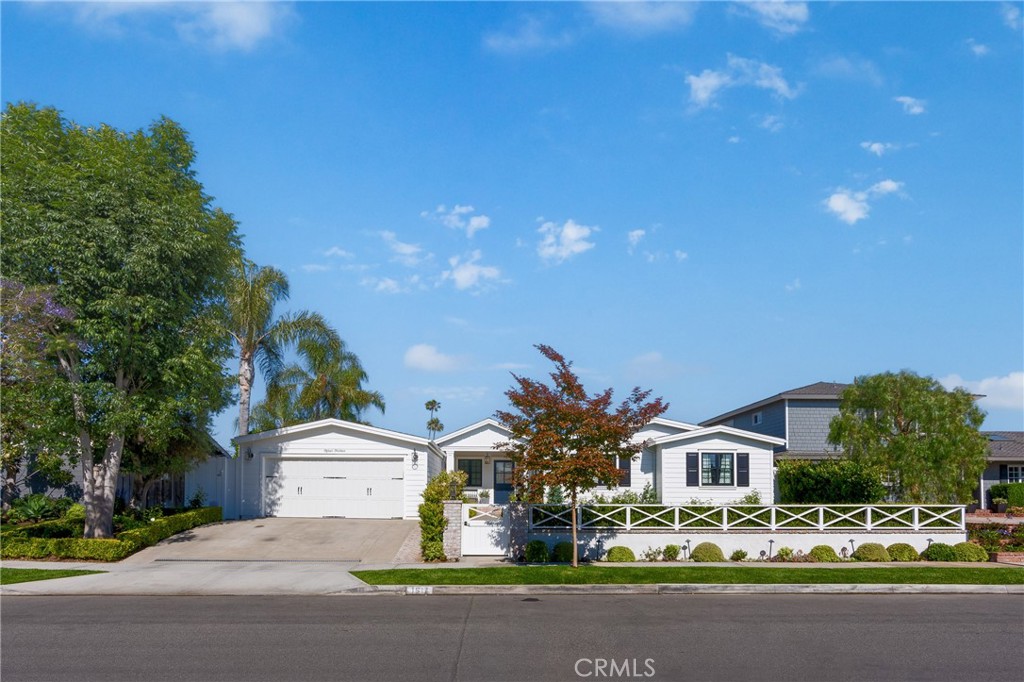 a front view of multiple houses with yard and green space