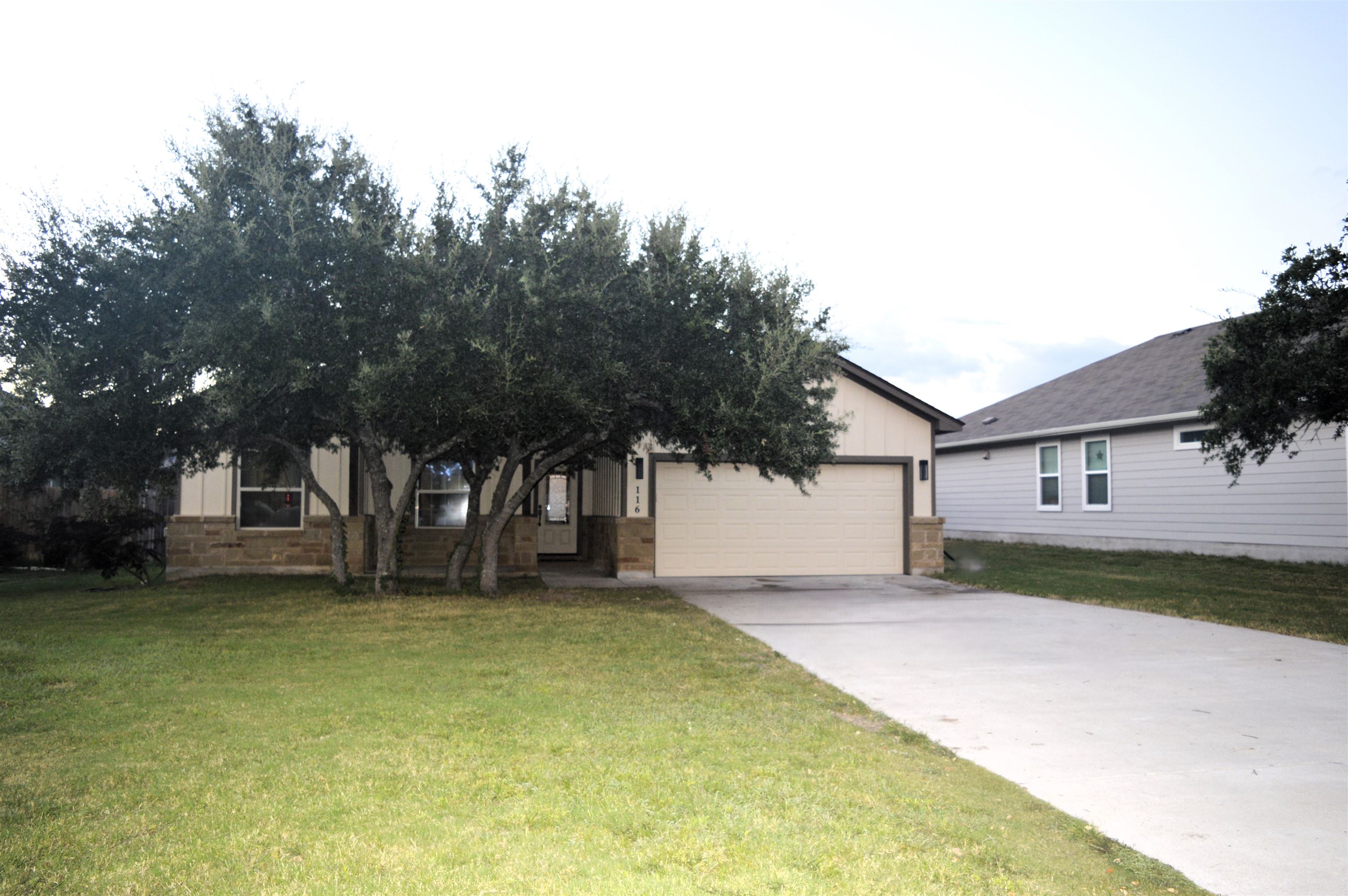 a view of a house with a yard and garage