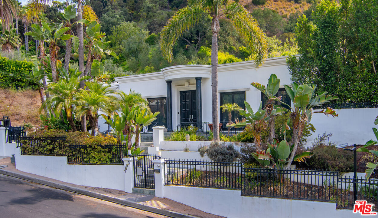 front view of house with potted plants