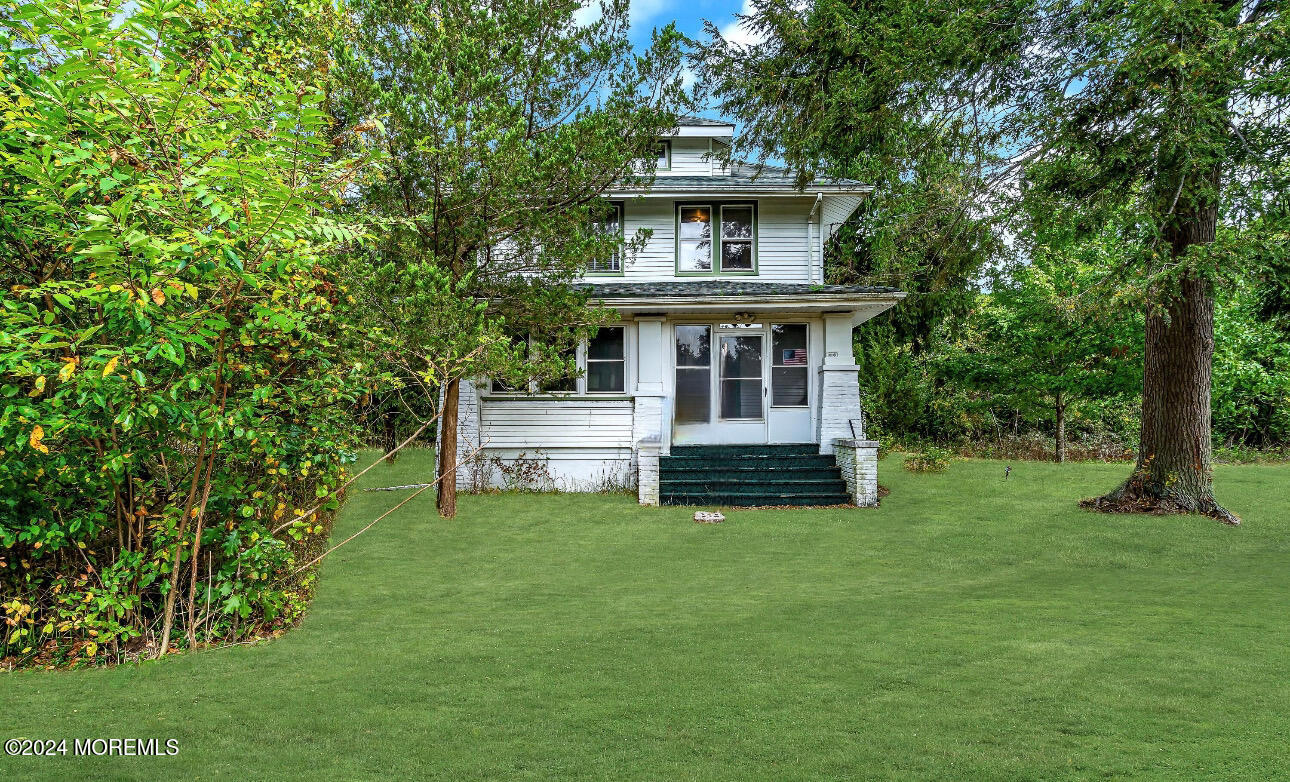 a view of a house with backyard sitting area and garden