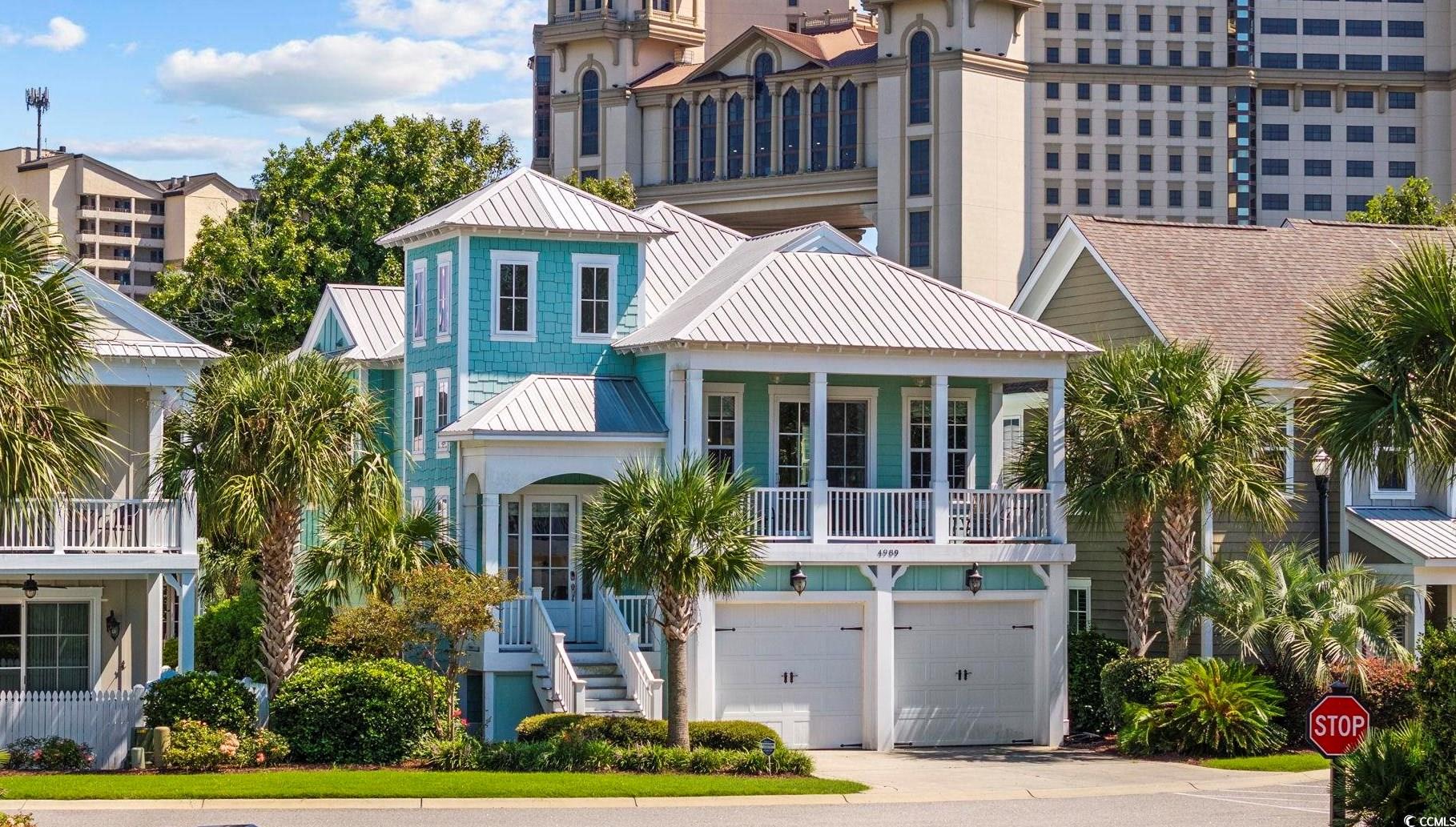 View of front of home featuring a balcony and a ga