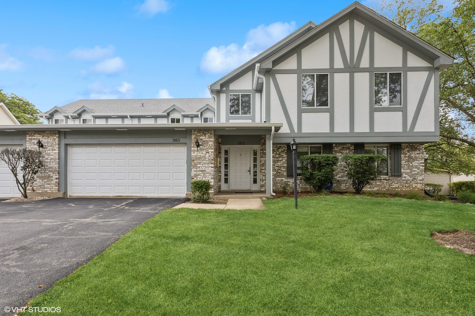 a front view of a house with a yard and garage