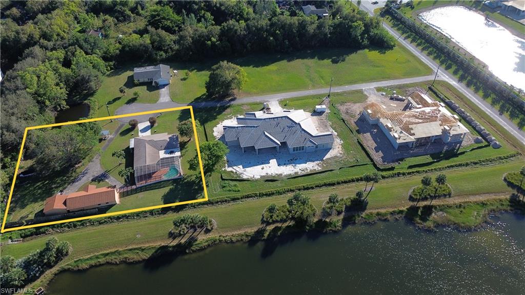 an aerial view of a houses with a yard