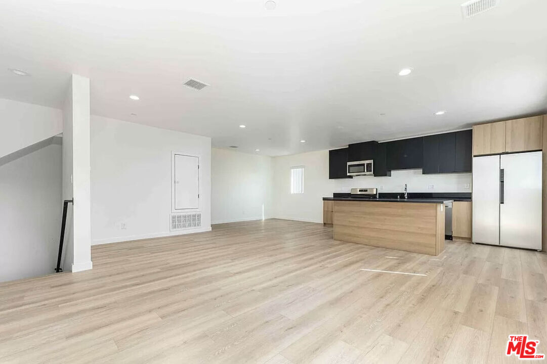 a view of kitchen with stainless steel appliances kitchen island