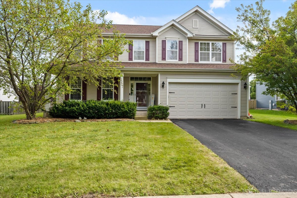 a front view of a house with a yard and garage