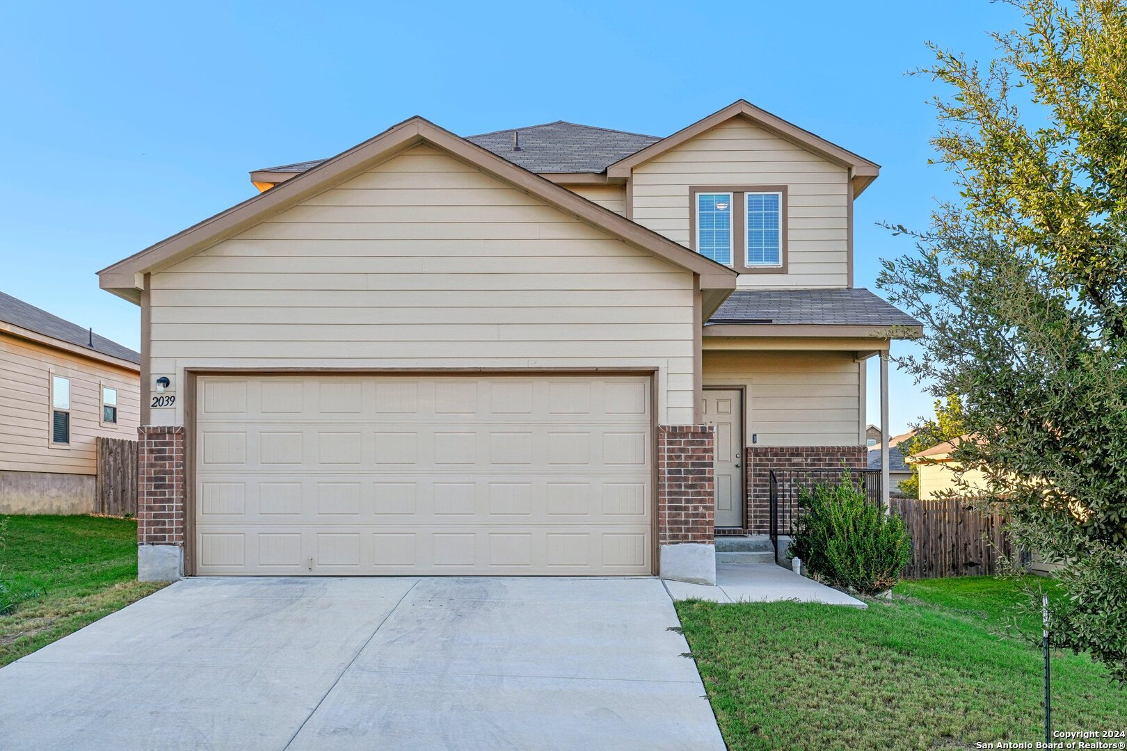 a front view of house with yard and green space