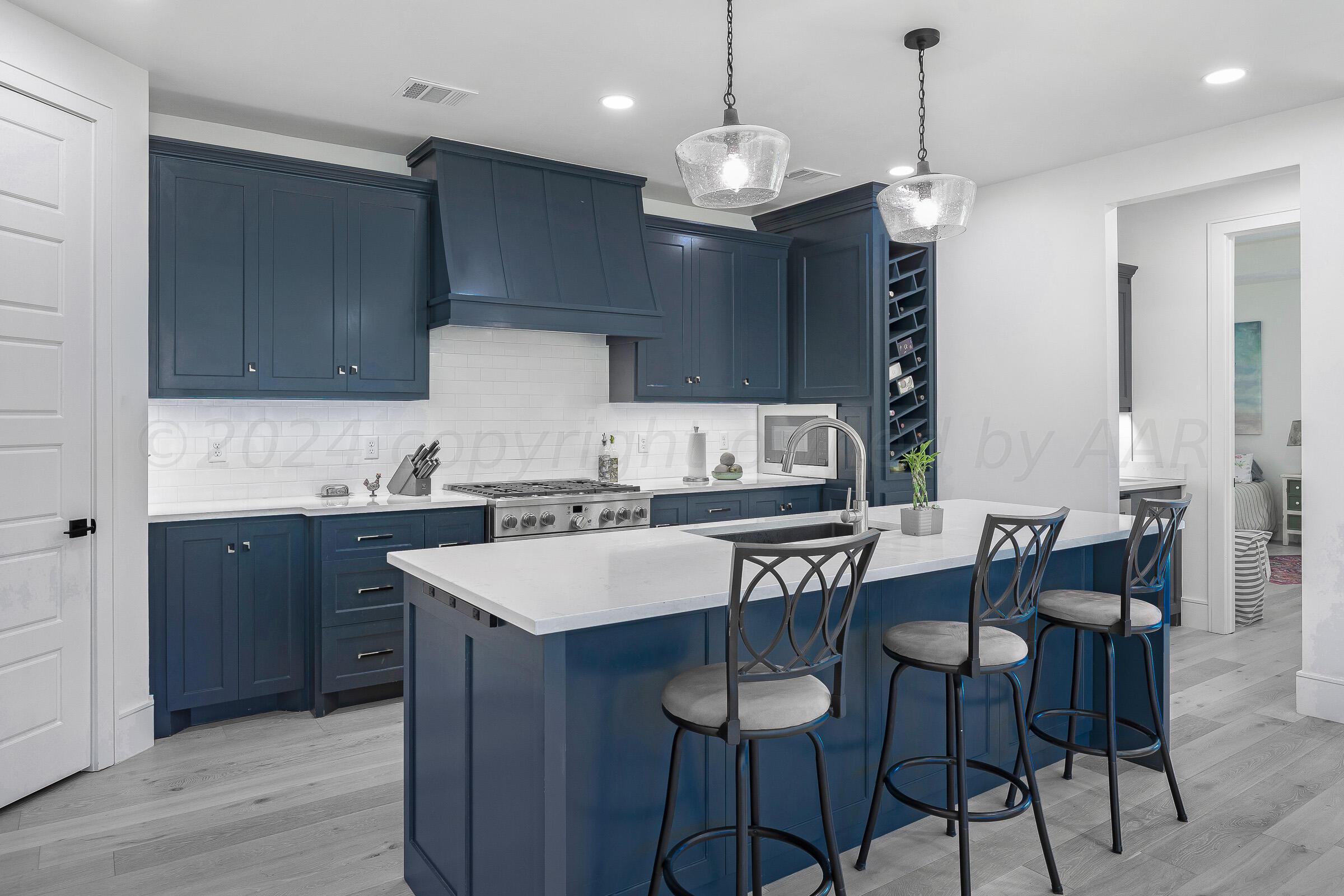 a kitchen with a dining table a sink and cabinets