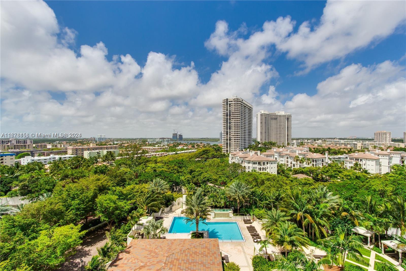 a view of a city with lush green forest