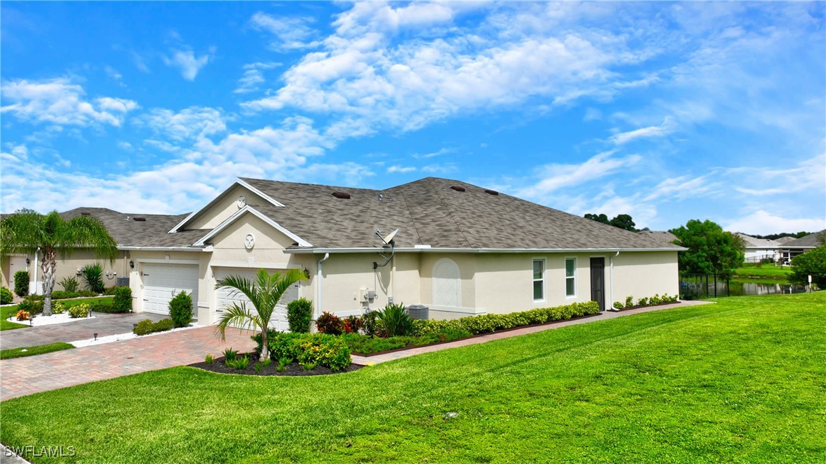 a front view of a house with a garden and yard