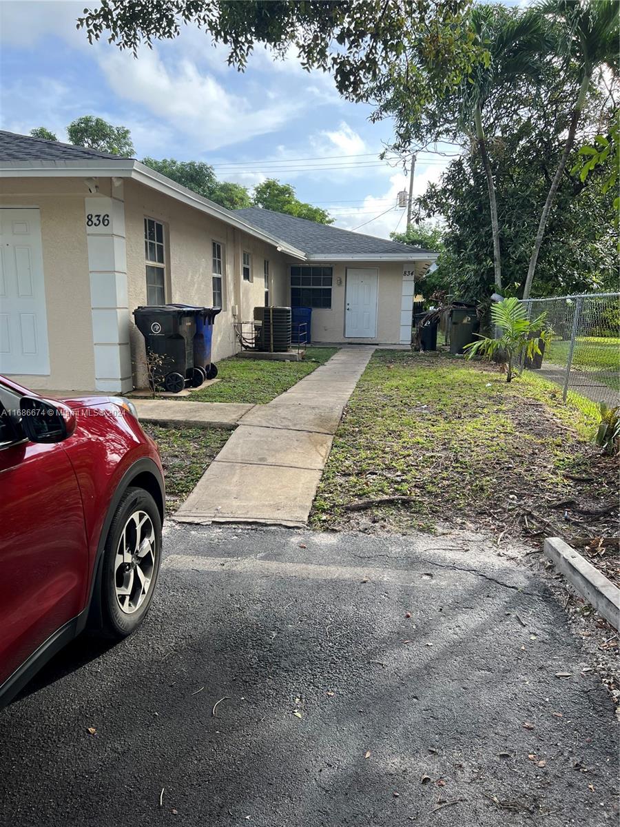 a blue house with trees in the background